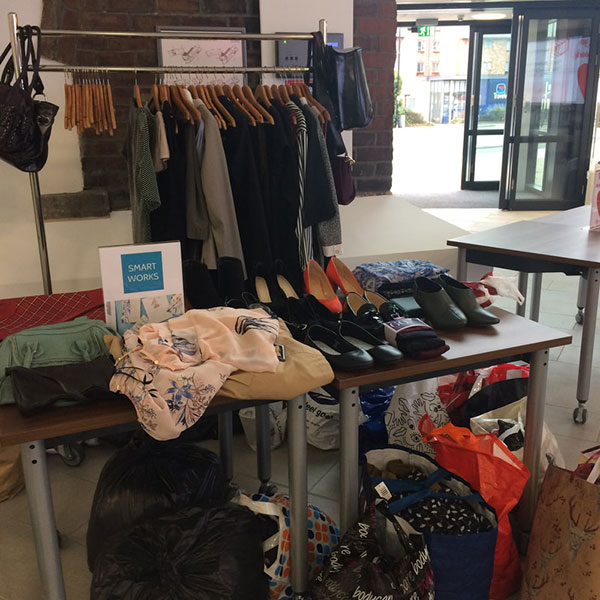Smart Works clothing rack overflowing with charitable donations.